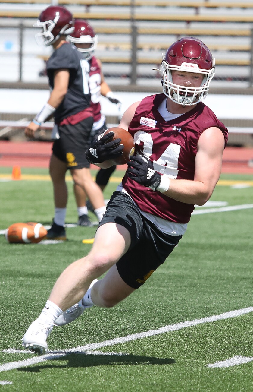 Bulldog tight end Cameron Miller (34) turns up field after making a catch during practice