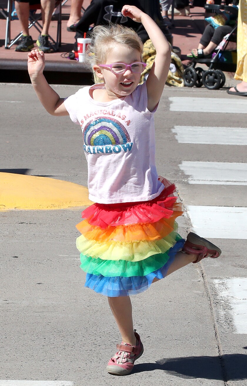 Eve Stalker, 4, of Duluth, dances in her rainbow skirt on Tower Avenue as she waits for the start of the Duluth-Superior Pride Parade