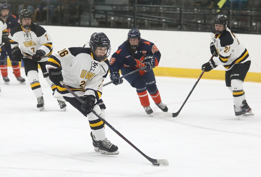 UW-Superior’s Lucy Drougas (26) moves the puck up the ice in the first period