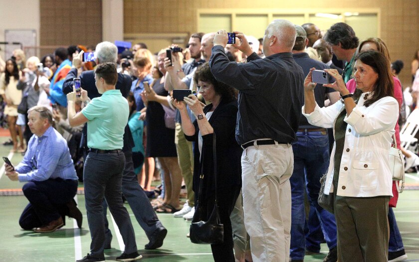 Guests use their cell phones to take pictures and video