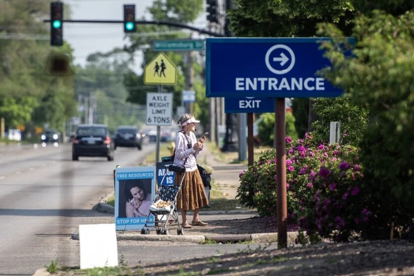 Woman protests outside of a Planned Parenthood clinic in Illinois