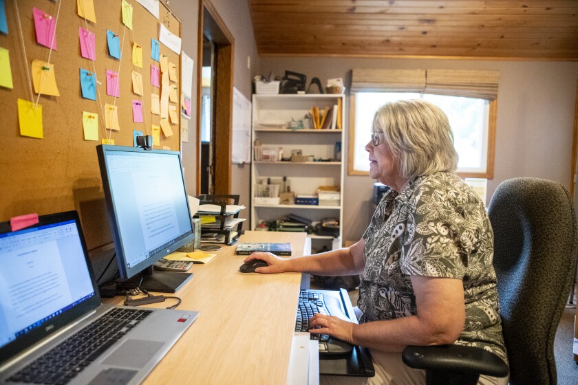 ME Fuller works on her most recent novel in her Montevideo home on Thursday, August 4, 2022.