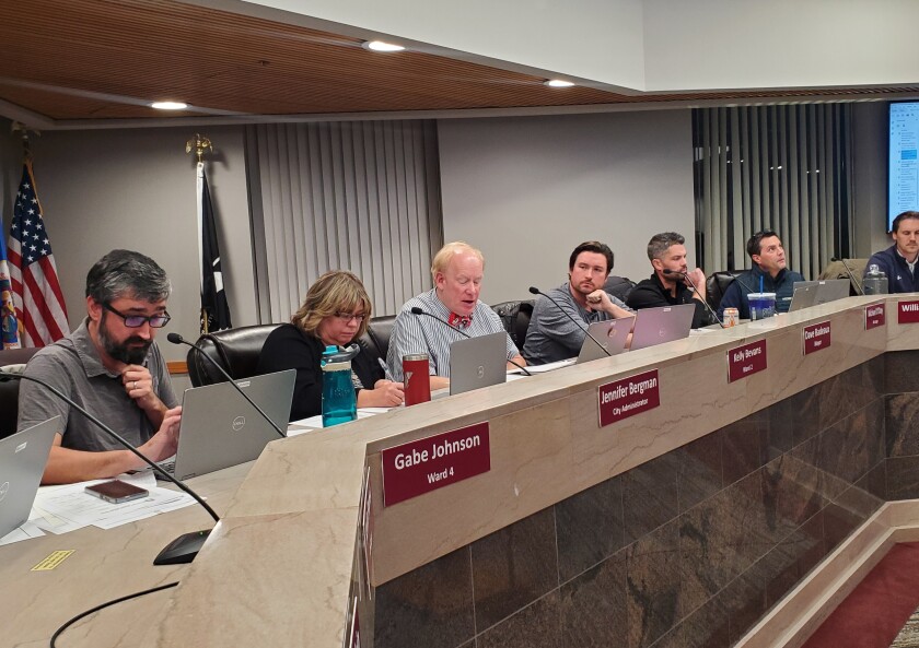 Council members sit in chambers
