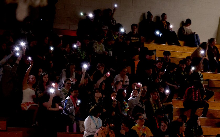 Students raise up their camera lights.