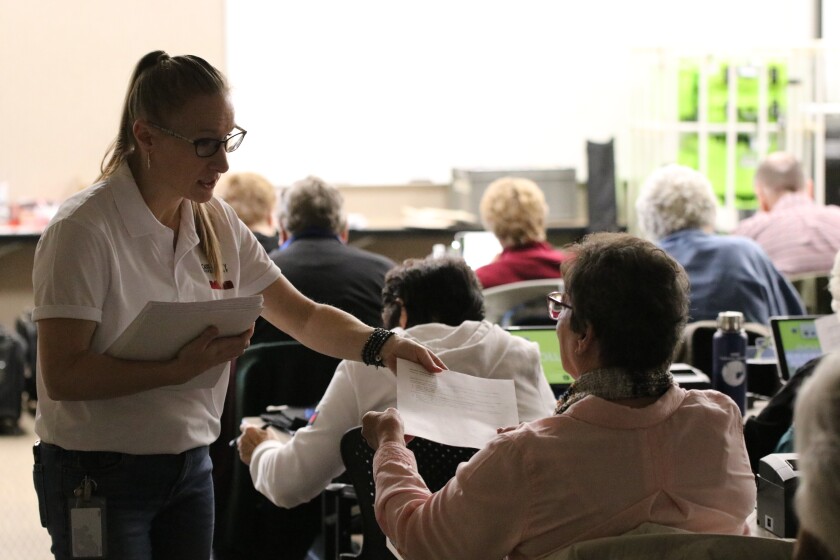 Brandy Madrigga, finance director for Cass County, hands out information to election judges and inspectors of the electoral board on Tuesday, Oct. 25, 2022.jpg