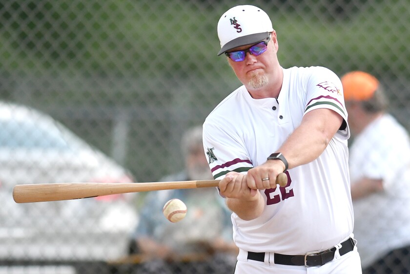 Coach hits balls to players.
