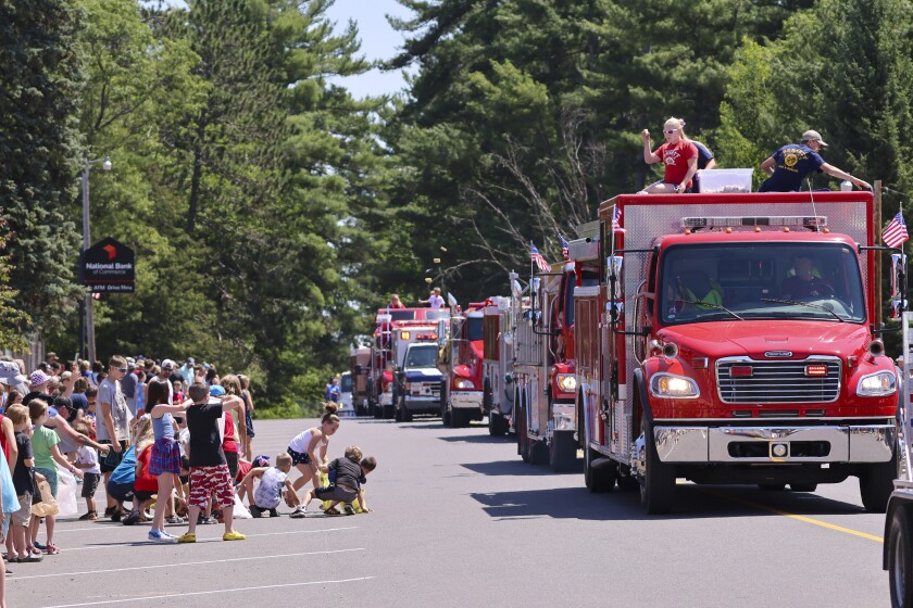 People wearing red white and blue patriotic themed clothing participating in outdoor parade