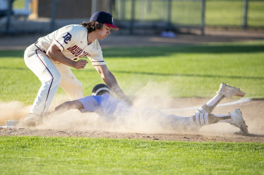 Cayden Hansen of Willmar American Legion Post 167 slides past third baseman Blake Morris of Dassel-Cokato during Willmar's opening game of the season at Bill Taunton Stadium on Thursday, June 16, 2022.