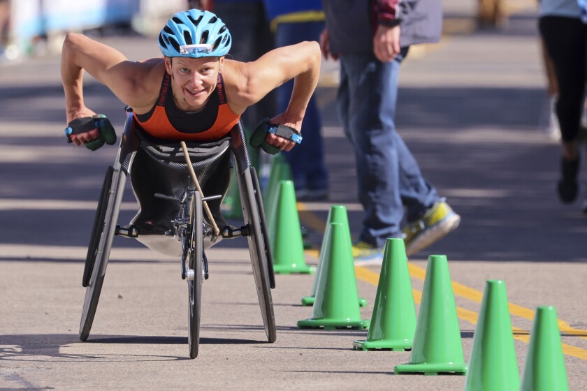 Athletes running and celebrating at the finish line area of Grandma's Marathon