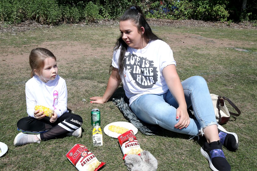 Ella Morse, 6, left, talks with her mom, Chelsea Rivers, about her upcoming first day of school on Tuesday as the two enjoy their food during the annual Duluth AFL-CIO Labor Day Picnic at Bayfront Festival Park