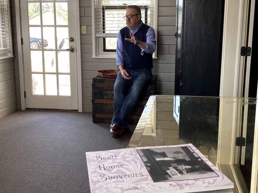 A man sitting and a book on a table