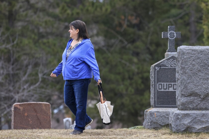 woman documents gravestones