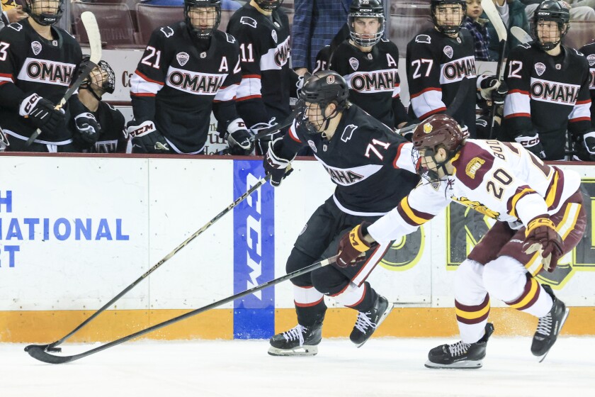 college men play ice hockey