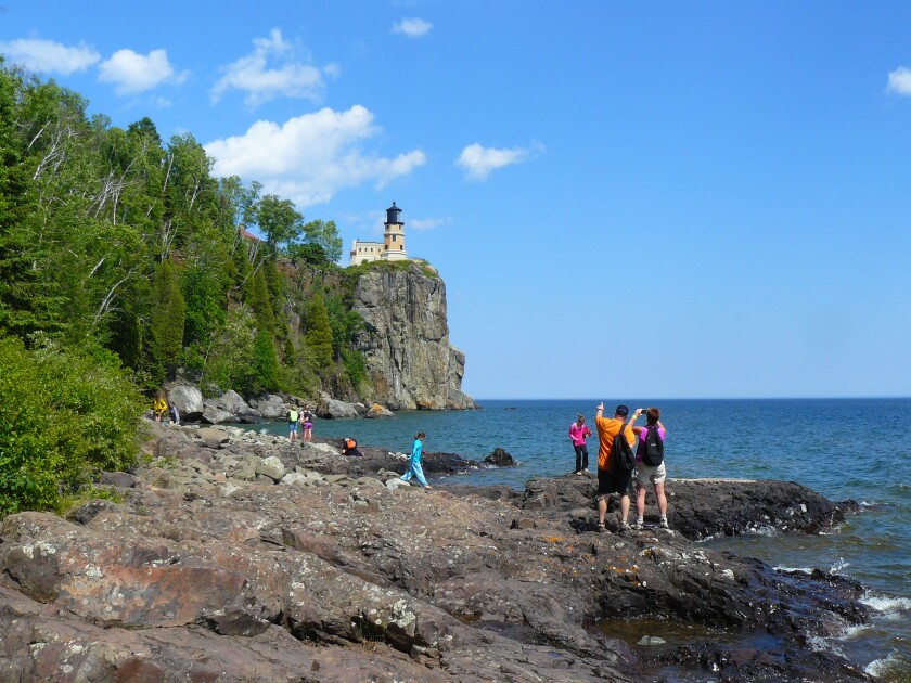 Visitors view lighthouse from the shoreline during the summer.jpg