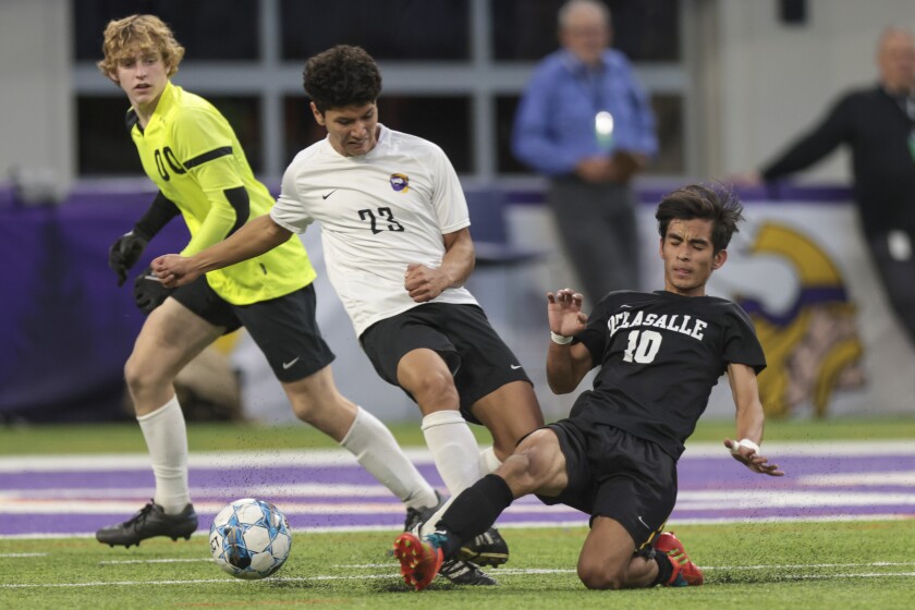 boys soccer players playing in indoor stadium