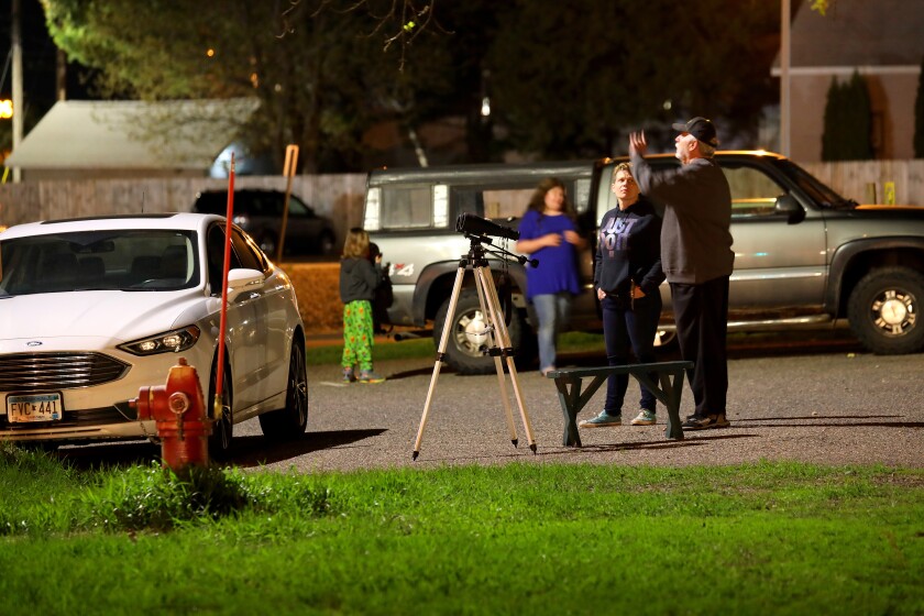 People watch the lunar eclipse.