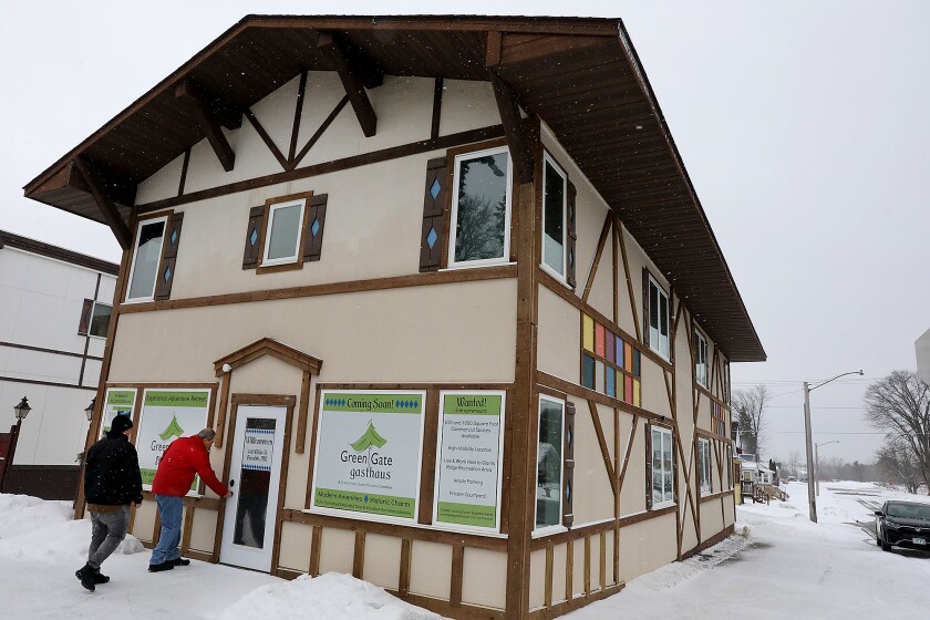 Biwabik Mayor Jim Weikum, right, opens the front door to the Green Gate Gasthaus in Biwabik