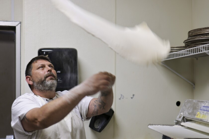 Man working in pizza restaurant