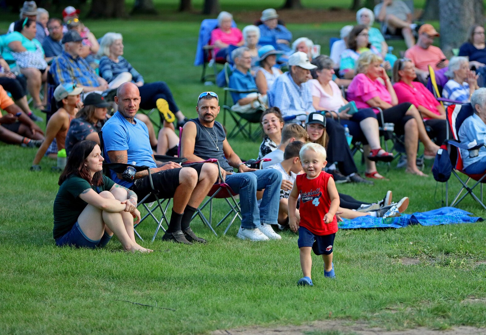 People enjoy a concert in the park