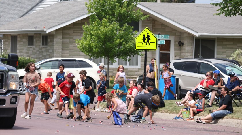 Children scramble for candy during the Independence Day Parade Monday, July 4, 2022, in Okabena.
