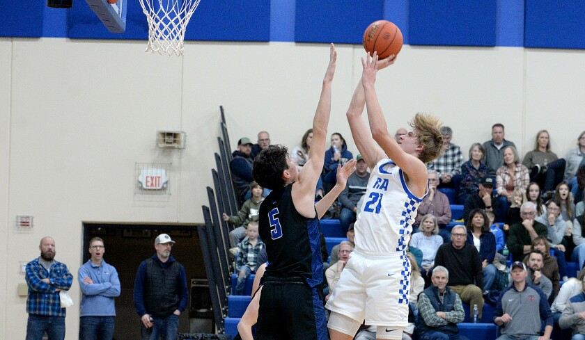 Heritage Christian Academy sophomore Aaron Palmer, right, shoots over CMCS' Asher Wieberdink during a non-conference game on Saturday, Dec. 14, 2024 at Prinsburg.