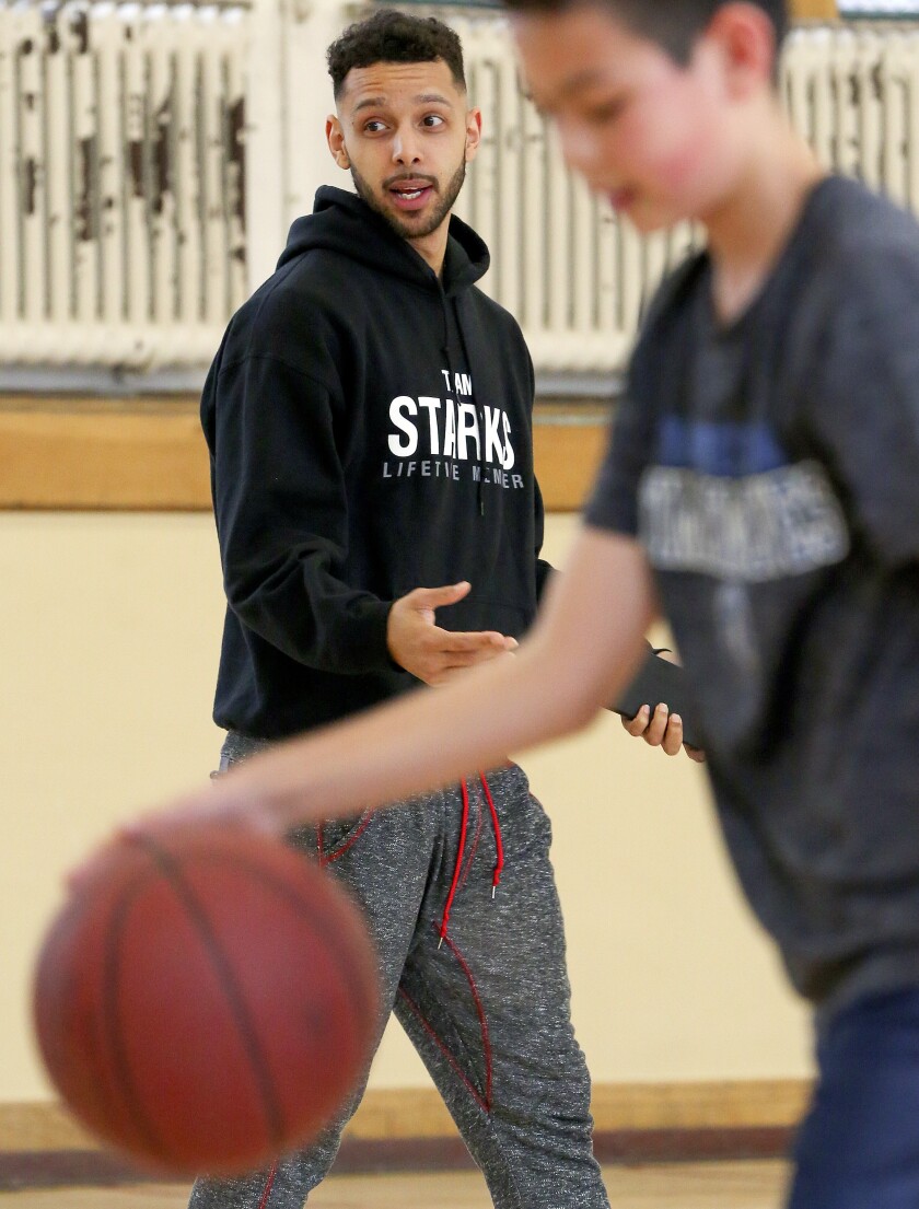 Dyami Starks gives advice to young basketball players during a recent session in the old Central High School gym. A 2010 Duluth East graduate, Starks scored 2,526 points with the Greyhounds. (Steve Kuchera / skuchera@duluthnews.com)