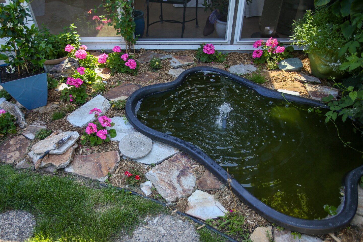 Alyssa Miller has a pond in her backyard at her home in south Fargo.