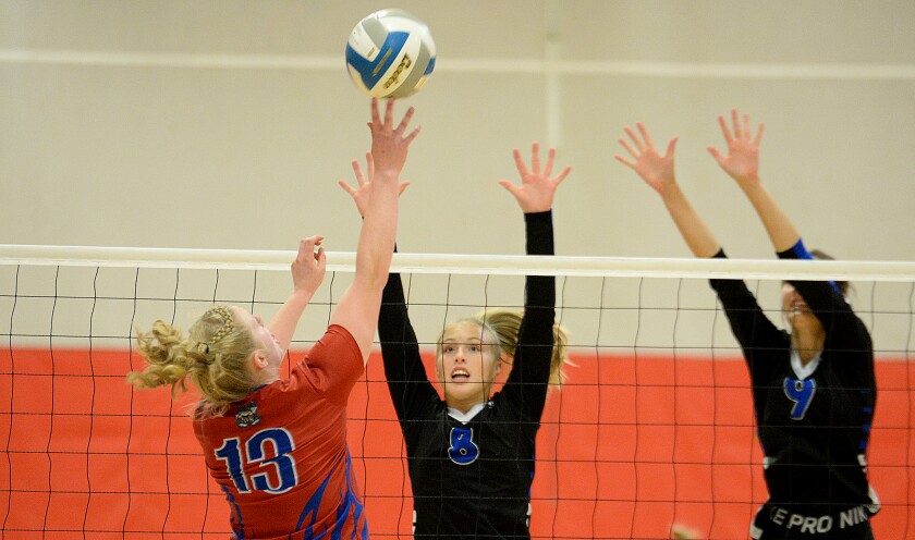 CMCS freshman Emmi Braem, 8, and junior Janessa Erickson, 9, go up for a block against KMS' Sophia Oerter during a Camden Conference match on Thursday, Sept. 29, 2022 in Kerkhoven.