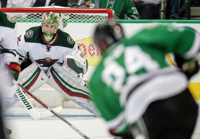 Nov 21, 2016; Dallas, TX, USA; Minnesota Wild goalie Darcy Kuemper (35) faces a shot by Dallas Stars defenseman Jordie Benn (24) during the third period at the American Airlines Center. The Stars defeat the Wild 3-2 in overtime. Mandatory Credit: Jerome Miron-USA TODAY Sports