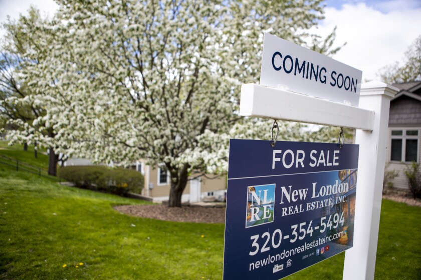 A home is marked with signage signaling that it will soon hit the market in New London on Saturday, May 21, 2022.