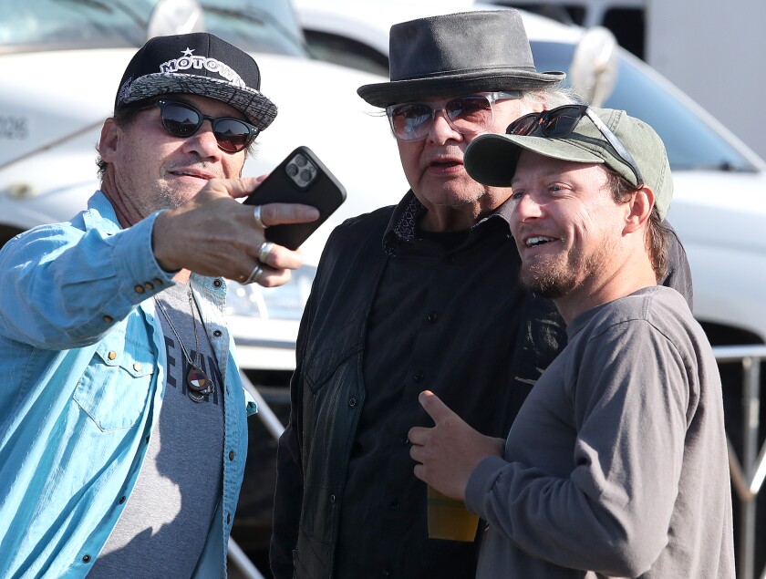 Todd Partridge, left, of Iowa, and Riley Partridge, right, of Duluth, take a selfie with Gary Farmer, who plays Uncle Brownie on the show Reservation Dogs, during the Water is Life Festival