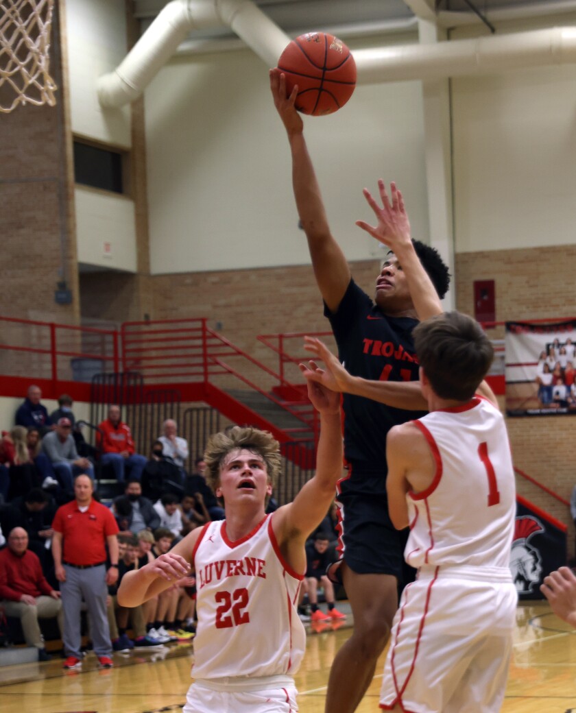 Worthington Trojans Jacari Swinea drives through the seam of Luverne Cardinals defense by Connor Overgaard (22) and Colin Schoeneman (1) during a Thursday evening game.