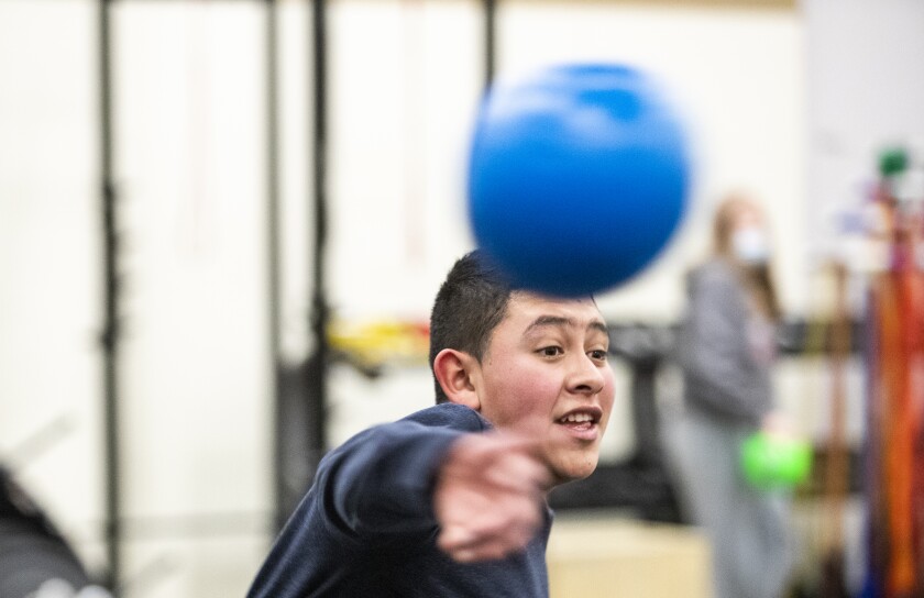 Hermis Alvarado, 13, throws a dodgeball during the after-school program at Willmar Middle School