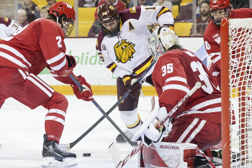 college hockey players play ice hockey