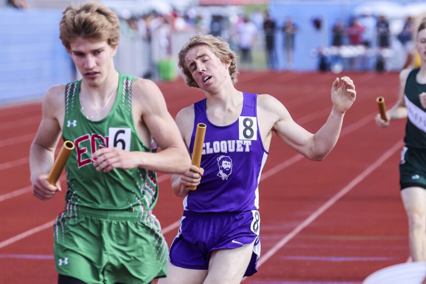 High school athletes compete in track and field events at outdoor stadium