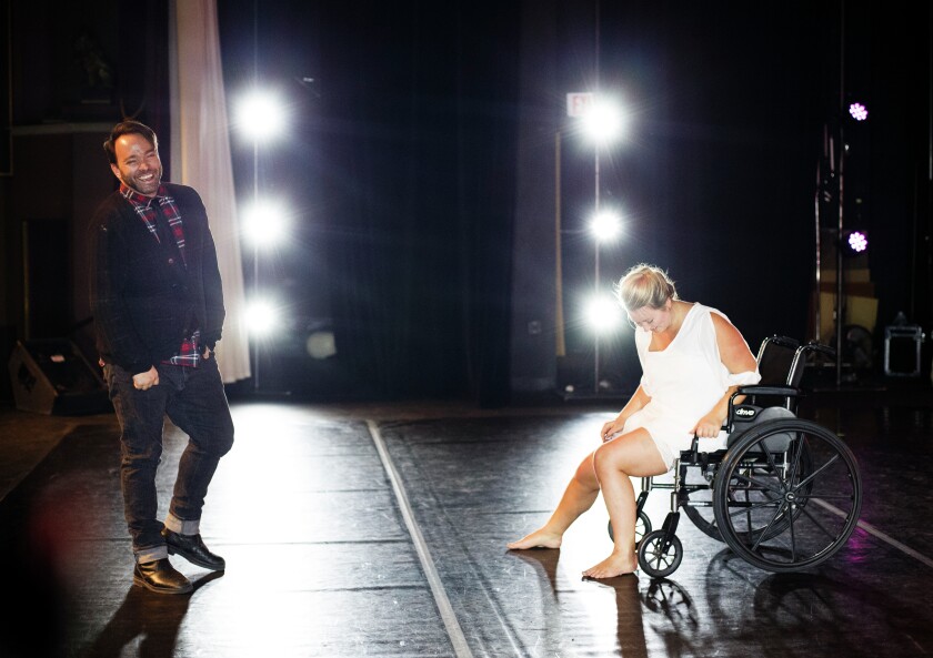 Job Christenson shares a laugh with Sue Moe on stage during a rehearsal for "Solitude and Solstice." Moe is portraying Christenson in the modern dance piece he created to depict, through dance, his experience with a stroke and the journey to recovery that followed. (Jesse Trelstad/Grand Forks Herald)