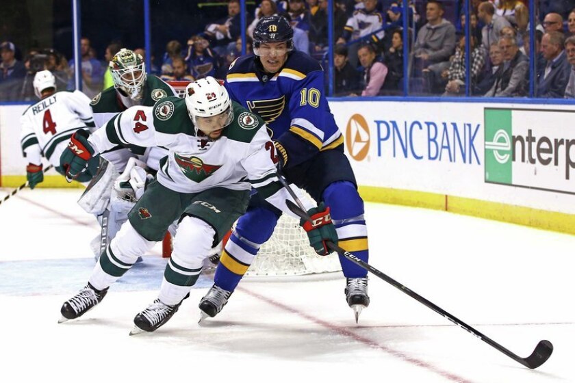 Minnesota Wild defenseman Matt Dumba (24) and St. Louis Blues right wing Scottie Upshall (10) battle for position for a loose puck in the corner during the second period at Scottrade Center. Photo by Billy Hurst-USA TODAY Sports