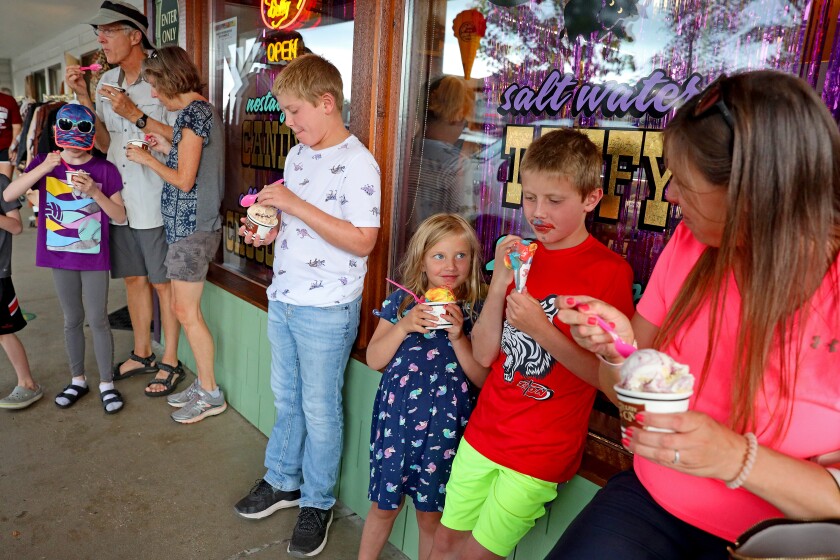 People eat ice cream outside of the Chocolate Ox in Nisswa.