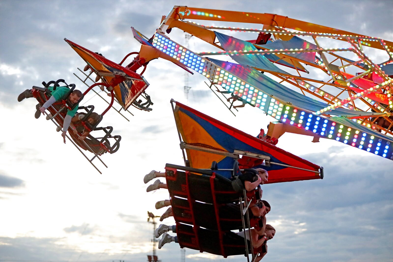 The fair midway ride Soarin' spins people around.