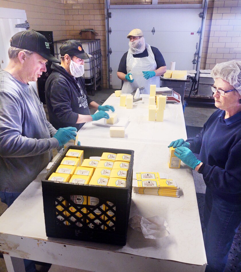 Wrapping and packing butter at the Millerville Creamery.
