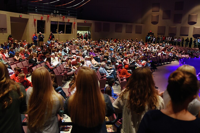Girls wait along the railing at the Willmar Senior High theater during the homecoming coronation ceremony Monday night. Briana Sanchez/West Central Tribune
