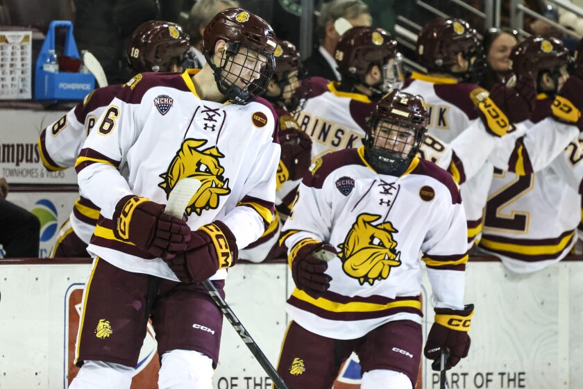 college men play ice hockey