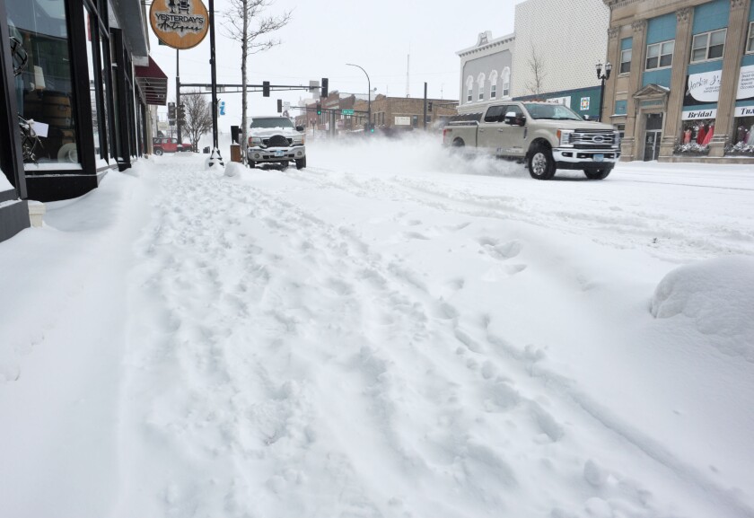 Tracks in snow on sidewalk