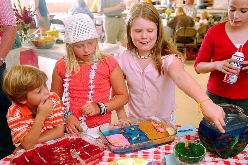 Children gawk at different colors and molds of jell-o in green, red, blue, pink and more.