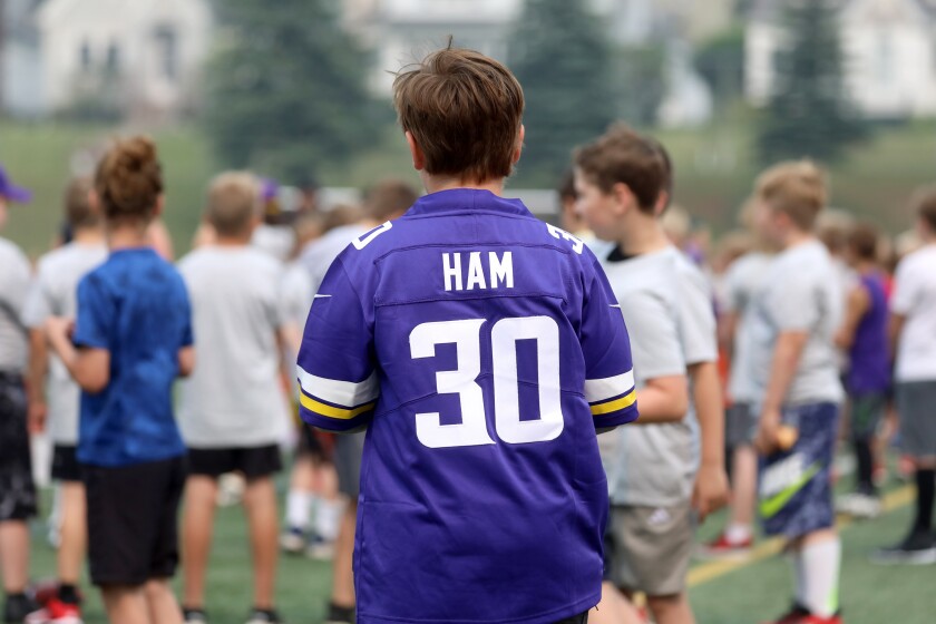A young boy wearing a replica football jersey.