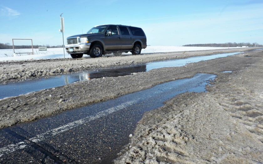 Douglas County Road 46 near the Alexandria Area High School was one of the many roads that became caked with ice in the first winter storm of the season. (Lowell Anderson | Echo Press)