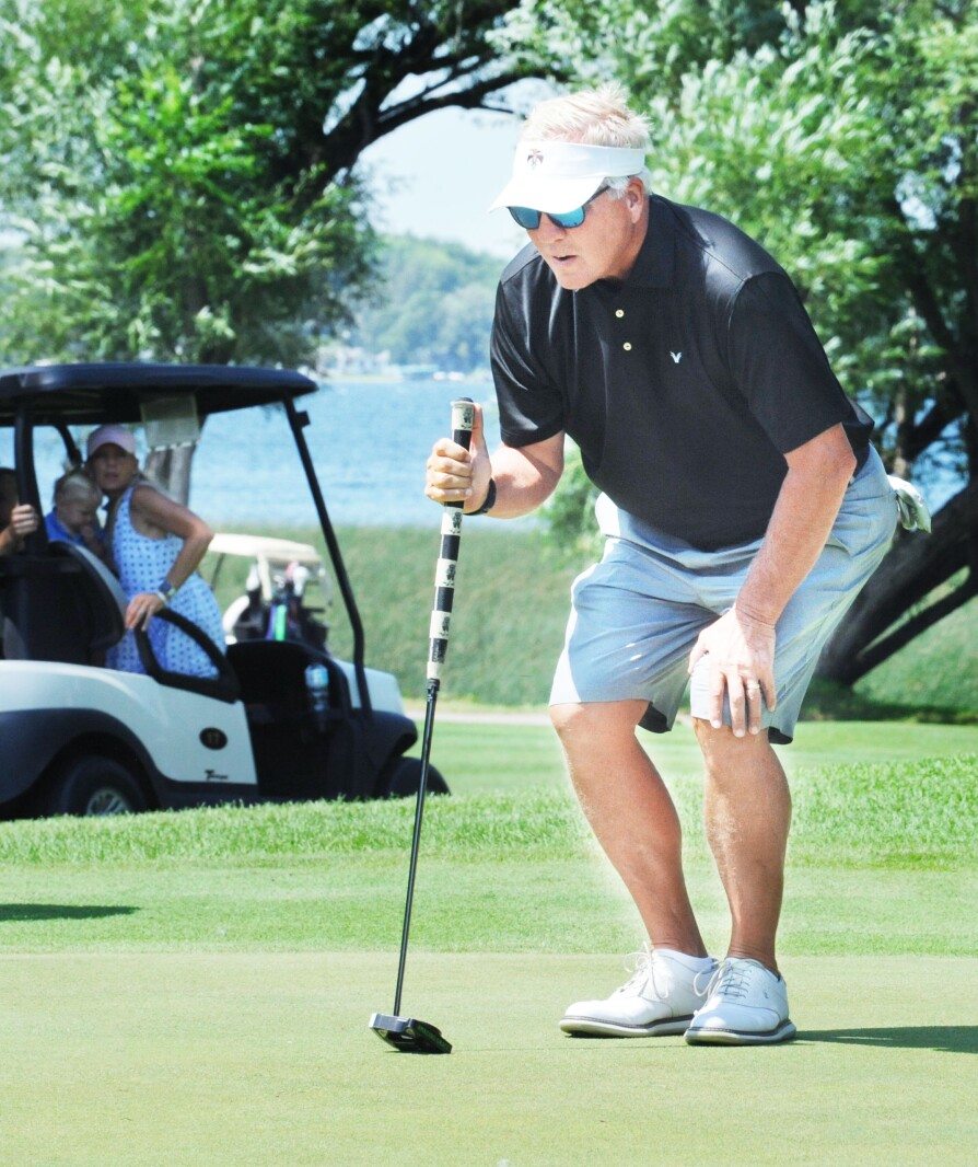 Mike Herzog lines up a putt on the No. 6 green during Friday's s