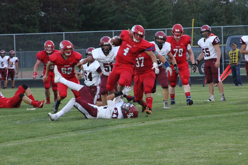 Dan Determan/Echo JournalNathan Traut hurdles a defender on the way to his first touchdown of the game against Staples-Motley on Thursday, Aug. 31.