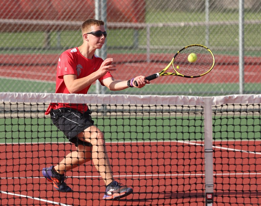 Worthington Trojans number 3 singles tennis player Ezra Bonnett returns a volley against Yellow Medicine East's Ryan Syring Tuesday afternoon.