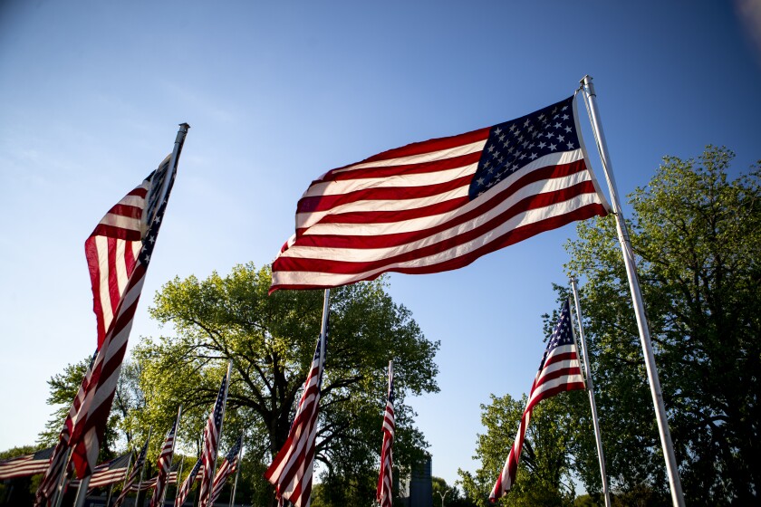 Following approximately 10 minutes of work by volunteers and veterans, 100 American flags wave in the early-morning breeze at the Flags of Honor Memorial in Willmar on Friday, May 27, 2022.